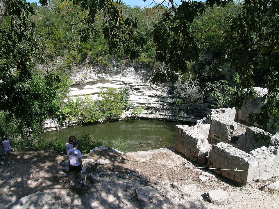 Group of visitors looking at the Sacred Cenote